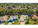 Aerial view of the house and the property in a well-treed neighborhood at 8248 Sugarbush Dr, Spring Hill, FL 34606
