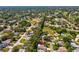 A well-treed residential area, shot from above, displays neatly arranged homes, landscaping, and curving roads at 8248 Sugarbush Dr, Spring Hill, FL 34606