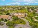 Aerial view of community featuring golf course, pool, clubhouse, and landscaping at 8248 Sugarbush Dr, Spring Hill, FL 34606