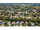 Aerial shot of a well-treed neighborhood featuring single-Gathering houses, landscaping, and roads at 8248 Sugarbush Dr, Spring Hill, FL 34606