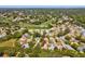 A neighborhood with landscaping and single-Gathering homes surrounds the fairways, ponds, and greens of a golf course at 8248 Sugarbush Dr, Spring Hill, FL 34606