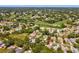 A neighborhood with landscaping and single-Gathering homes surrounds the fairways, ponds, and greens of a golf course at 8248 Sugarbush Dr, Spring Hill, FL 34606