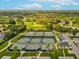 Aerial view of tennis courts and golf course providing recreational opportunities at 8248 Sugarbush Dr, Spring Hill, FL 34606