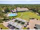 Aerial view of community lodge, pool, golf course, putting green, and golf cart parking at 8248 Sugarbush Dr, Spring Hill, FL 34606