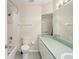 Bathroom with tiled shower, toilet and vanity sink with a long mirror at 8248 Sugarbush Dr, Spring Hill, FL 34606