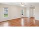 Bright bedroom boasts beautiful hardwood floors and a ceiling fan, offering comfort and style at 8248 Sugarbush Dr, Spring Hill, FL 34606
