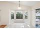 Cozy breakfast nook surrounded by bay windows, offering a view of the landscaped backyard at 8248 Sugarbush Dr, Spring Hill, FL 34606