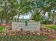 Timber Pines Lodge & Activity Center sign with lush landscaping and mature trees in the background at 8248 Sugarbush Dr, Spring Hill, FL 34606