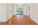 Open dining room featuring hardwood floors and a sliding glass door to the sunroom at 8248 Sugarbush Dr, Spring Hill, FL 34606