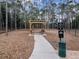 Image of community dog park featuring seating, shade, and pet waste station at 8248 Sugarbush Dr, Spring Hill, FL 34606