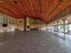 Large event space featuring a wooden ceiling, stone fireplace, and expansive windows at 8248 Sugarbush Dr, Spring Hill, FL 34606