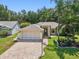 Charming home featuring a brick-paved driveway, well-manicured lawn, and a two-car garage at 8248 Sugarbush Dr, Spring Hill, FL 34606