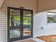 Exterior view of Fitness Center with double doors and light gray siding at 8248 Sugarbush Dr, Spring Hill, FL 34606