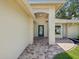 Inviting front porch with brick columns and a tiled walkway leading to the entrance at 8248 Sugarbush Dr, Spring Hill, FL 34606