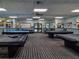 Well-lit game room featuring multiple pool tables and comfortable seating areas at 8248 Sugarbush Dr, Spring Hill, FL 34606
