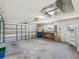 Spacious two-car garage featuring ample storage, workbench area, and epoxy flooring at 8248 Sugarbush Dr, Spring Hill, FL 34606
