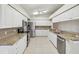 Bright kitchen featuring white cabinetry, stainless steel appliances, and granite countertops at 8248 Sugarbush Dr, Spring Hill, FL 34606