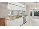 Bright kitchen with granite countertops and stainless steel appliances, breakfast bar and white cabinets at 8248 Sugarbush Dr, Spring Hill, FL 34606