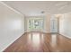 Bright living room featuring hardwood floors, large window, and stylish light fixtures at 8248 Sugarbush Dr, Spring Hill, FL 34606