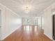 Spacious living room with hardwood flooring, decorative lighting, and a large bay window at 8248 Sugarbush Dr, Spring Hill, FL 34606