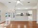 Open-concept living room with hardwood floors and view of the kitchen and breakfast nook at 8248 Sugarbush Dr, Spring Hill, FL 34606