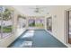 Enclosed sunroom with lots of windows, ceiling fan, and sliding glass door to the outside at 8248 Sugarbush Dr, Spring Hill, FL 34606