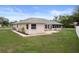 Well-maintained backyard with green lawn, nice landscaping, and view of the home's exterior at 8283 Shoup St, Spring Hill, FL 34606