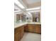Bathroom featuring dual sinks, ample counter space, and a large mirror at 8283 Shoup St, Spring Hill, FL 34606