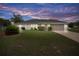 Charming one-story home with manicured lawn and mature landscaping against a beautiful sunset at 8283 Shoup St, Spring Hill, FL 34606