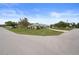 Street view of the home with well-maintained landscaping, lawn and neighborhood at 8283 Shoup St, Spring Hill, FL 34606