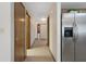 Hallway leading to other rooms and showing the stainless steel refrigerator at 8283 Shoup St, Spring Hill, FL 34606