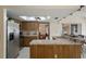 Open eat-in kitchen area, with barstool seating and stainless appliances at 8283 Shoup St, Spring Hill, FL 34606