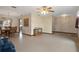 Inviting living room area showcasing tile floors and seamless transition to the dining space at 8283 Shoup St, Spring Hill, FL 34606