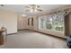 Bright and airy living room area with tile floors, large window, and comfortable ambiance at 8283 Shoup St, Spring Hill, FL 34606