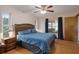 Bedroom with wood-look floors, and large window with views of the fenced-in backyard at 8283 Shoup St, Spring Hill, FL 34606