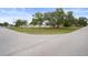 Peaceful street scene in a quiet neighborhood with well-maintained lawns and mature trees at 8283 Shoup St, Spring Hill, FL 34606