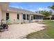 Outdoor patio area with seating, a grill and access to the sunroom at 8283 Shoup St, Spring Hill, FL 34606