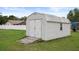 Exterior view of a shed, with a yard, and double doors at 8283 Shoup St, Spring Hill, FL 34606
