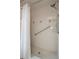 Close-up of a clean, well-maintained shower with a grab bar and modern showerhead at 8283 Shoup St, Spring Hill, FL 34606