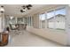 Inviting sunroom with tile floors, light fixtures, large windows, and comfortable seating at 8283 Shoup St, Spring Hill, FL 34606