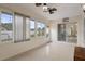 Open sunroom with tile flooring, many windows, and sliding glass door at 8283 Shoup St, Spring Hill, FL 34606