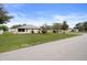 Suburban yard with green grass, a shed, landscaping and a glimpse of the home's exterior at 8283 Shoup St, Spring Hill, FL 34606