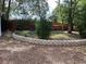Lush backyard features a stone retaining wall and privacy fence, creating a serene outdoor space at 8291 Weeping Willow St, Brooksville, FL 34613