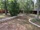Landscaped backyard featuring decorative stone retaining walls and natural growth at 8291 Weeping Willow St, Brooksville, FL 34613