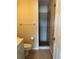 Bathroom with walk in shower, toilet, and sink with storage underneath at 8291 Weeping Willow St, Brooksville, FL 34613