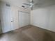 Bedroom featuring carpeted floors, a ceiling fan, and closet at 8291 Weeping Willow St, Brooksville, FL 34613