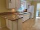 Bright eat-in kitchen area with white cabinets, stainless sink, and granite countertop at 8291 Weeping Willow St, Brooksville, FL 34613