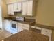 Kitchen with white cabinets, countertops, and stainless appliances at 8291 Weeping Willow St, Brooksville, FL 34613