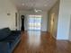 Spacious living room with ceiling fan and sliding glass doors leading to a sunroom at 8291 Weeping Willow St, Brooksville, FL 34613