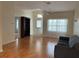 Bright living room with hardwood floors, ceiling fan, and view of the front entrance at 8291 Weeping Willow St, Brooksville, FL 34613